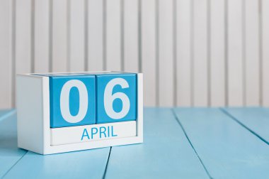 April 6th. Image of april 6 wooden color calendar on white background.  Spring day, empty space for text