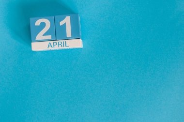 April 21st. Image of april 21 wooden color calendar on blue background.  Spring day, empty space for text