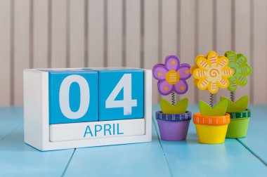 April 4th. Image of april 4 wooden color calendar on white background with flowers. Spring day, empty space for text. Webmaster Day