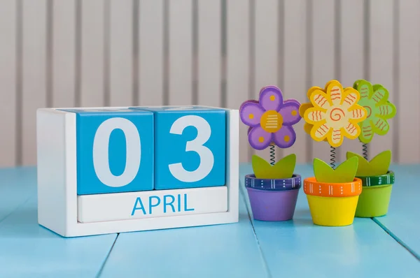 Il 3 aprile. Immagine di 3 aprile calendario a colori in legno su sfondo bianco con fiori. Primavera, spazio vuoto per il testo — Foto Stock