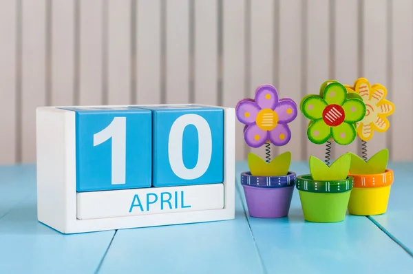 10 de Abril. Imagem de 10 de abril calendário de cor de madeira no fundo branco com flores. Dia de primavera, espaço vazio para texto. Dia Internacional de movimento de resistência — Fotografia de Stock