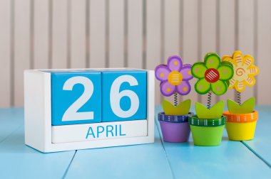 April 26th. Image of april 26 wooden color calendar on white background with flowers. Spring day, empty space for text