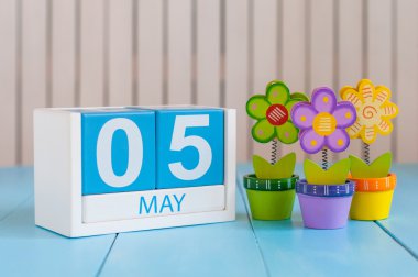 May 5th. Image of may 5 wooden color calendar on white background with flowers. Spring day, empty space for text. International disabled rights  Day