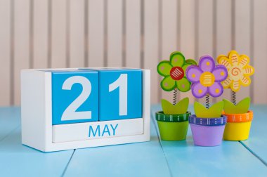 May 21st. Image of may 21 wooden color calendar on white background with flowers. Spring day, empty space for text