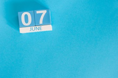 June 7th. Image of june 7 wooden color calendar on blue background. Summer day, empty space for text