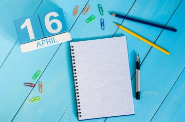 April 16th. Image of april 16 wooden color calendar on white background.  End month. Spring day, empty space for text