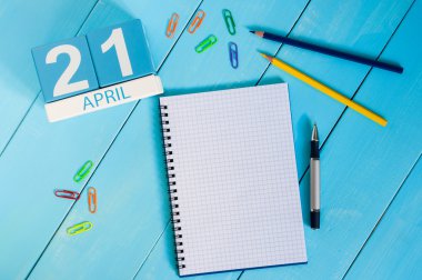 April 21st. Image of april 21 wooden color calendar on blue background.  Spring day, empty space for text