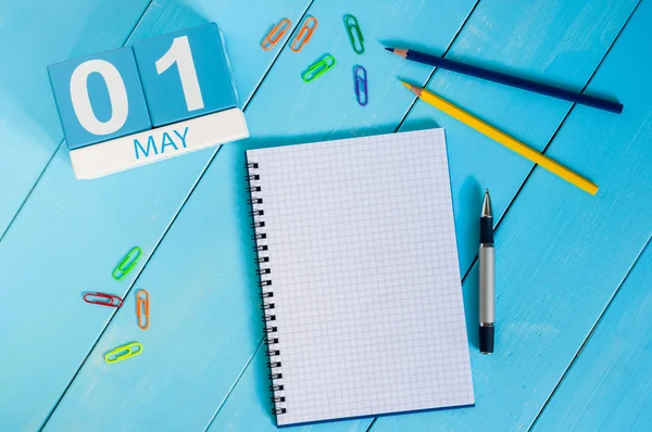 May 1st. Image of may 1 wooden color calendar on blue background.  Spring day, empty space for text.  International Workers Day — Stock Photo, Image