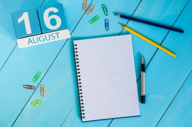 August 16th. Image of august 16 wooden color calendar on blue background. Summer day. Empty space for text clipart