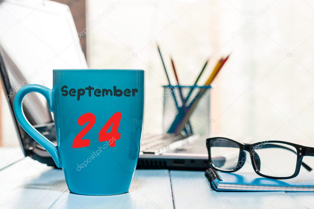 September 24th. Day 24 of month, calendar on coffee cup at Information Officer workplace background. Autumn time. Empty space for text