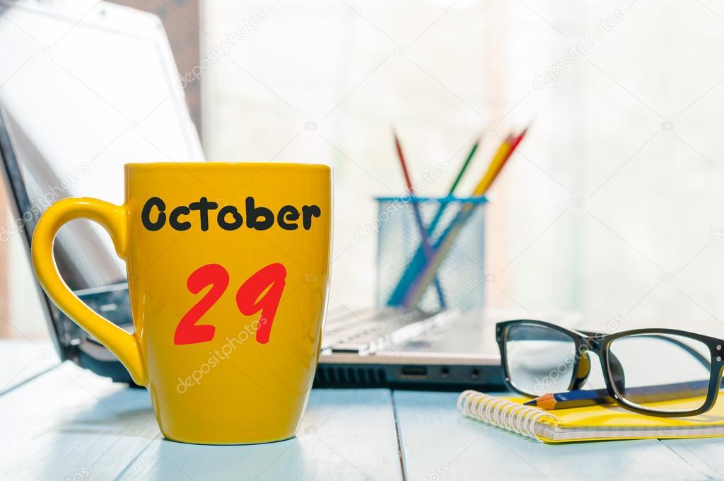 October 29th. Day 29 of month, hot drink cup with calendar on human-resources manager workplace background. Autumn time. Empty space for text