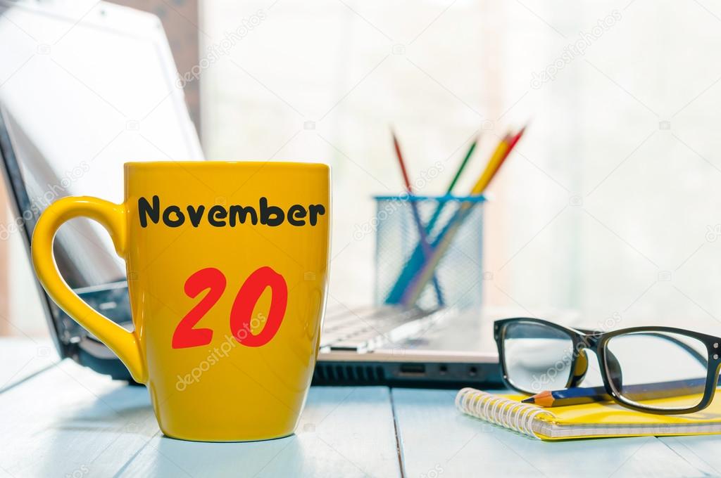 November 20th. Day 20 of month, calendar on yellow tea cup at Software Engineer workplace background. Autumn time. Empty space for text