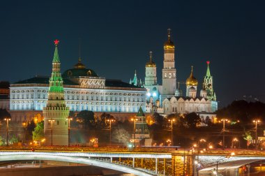 Evening in Moscow. Night view of the Kremlin and bridge illuminated by lights. clipart