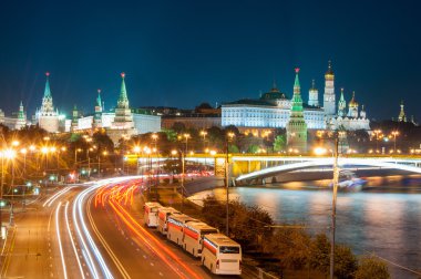 Evening in Moscow. Night view of the Kremlin and bridge illuminated by lights. clipart