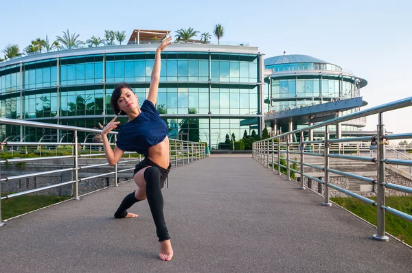 Girl stands in acrobatic positions, lifting his hands up. Acrobatics, ballet, dance. Outdoor — Stock Photo, Image