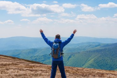 Tourist, man and success in mountains, arms raised. Running, sports, fitness healthy lifestyle outdoors, autumn nature