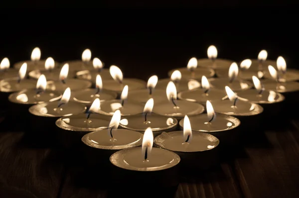 Candles on old wooden background — Stock Photo, Image