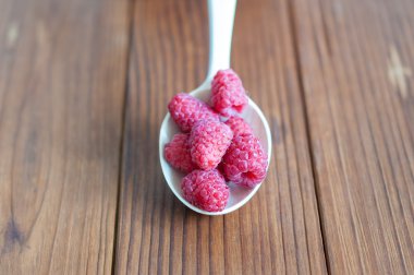 Raspberries antioxidant organic superfood in a wooden spoon concept for healthy eating and nutrition