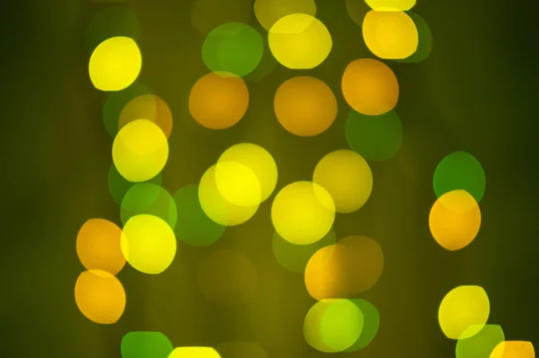 Luzes bokeh desfocadas amarelas e verdes — Fotografia de Stock