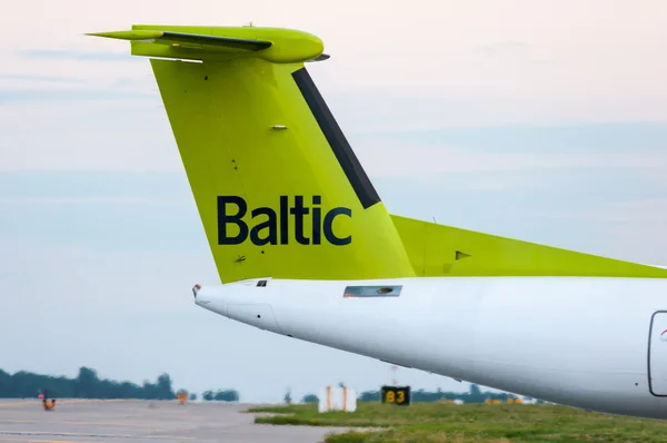 KIEV, UKRAINE - JULY 10, 2015:  The tail of the aircraft Air Baltic propeller airplane taxis to teminal at International Borispol airport. Airbaltic is Latvian national airline — Stock Photo, Image