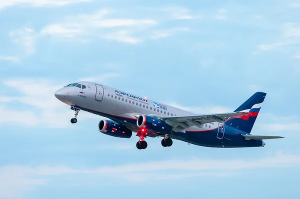 KIEV, UKRAINE - JULY 10, 2015: Aeroflots  SSJ 195-b take off at KBP Airport on January 12, 2014. Aeroflot is flag carrier and largest airline of the Russian Federation. — Zdjęcie stockowe