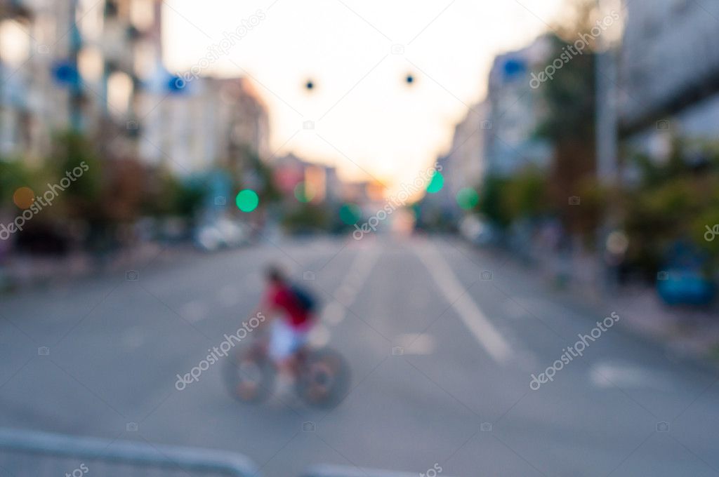 Abstract blurred image of man on bicycle in the city.