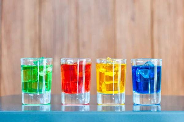 Vários cocktails alcoólicos em um balcão de bar com fundo de madeira — Fotografia de Stock