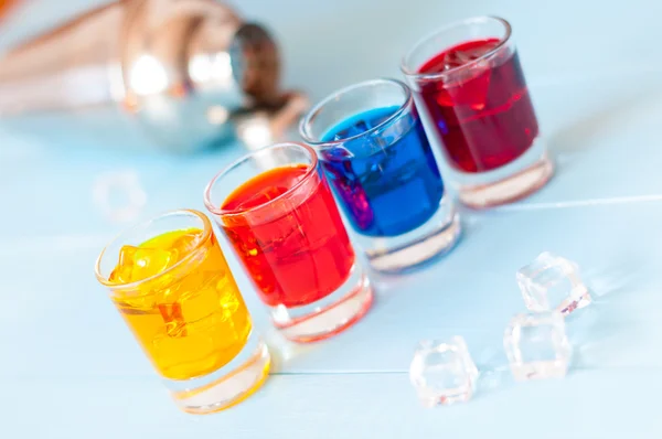 Set of alcoholic cocktails with metal shaker on white bar counter or light background. Selective focus — Stock Photo, Image