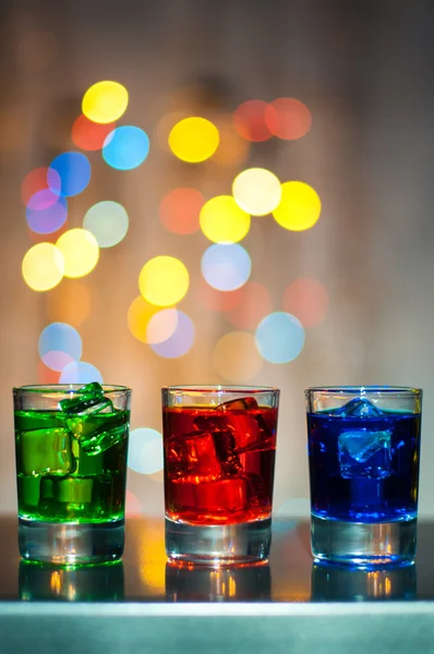 Three shot glasses with cocktail or liquor. Happy party background — Stock Photo, Image