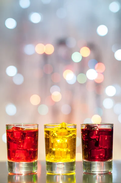 Three glasses with berry liqueur on the bar at a nightclub — Stock Photo, Image
