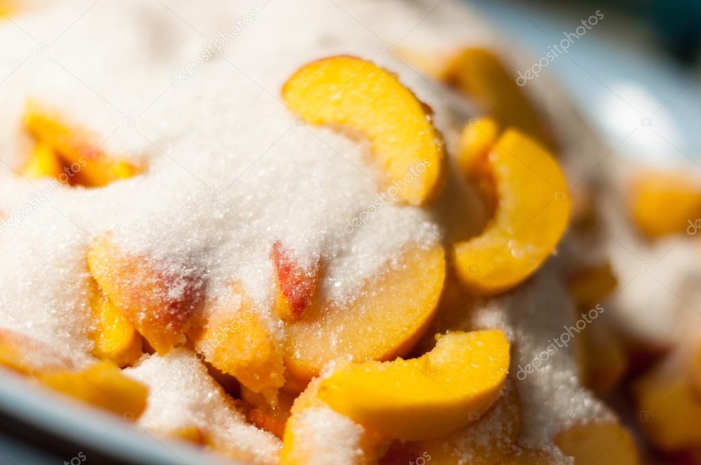 Peach slices with sugar, cooking jam. Selective focus