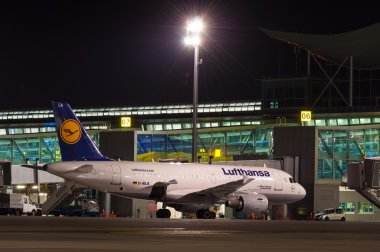 KIEV, UKRAINE - JULY 10, 2015: Lufthansa aircraft stay near terminal of airport and ready for boarding on July 10,2015 in Borispol, Ukraine. On this route operates the Lufthansas Flagship airplane. clipart