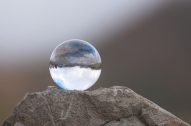 Cam üst kısmında rock ve koyu arka plan şeffaf topun. Yumuşak odak. Metin için boş alan ile