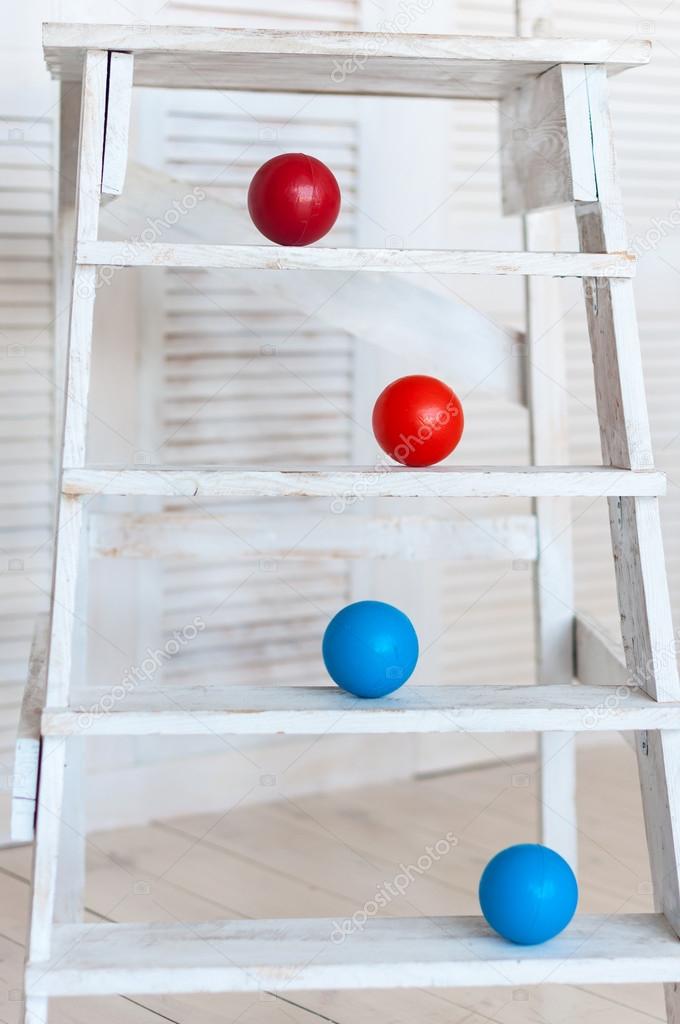Colour plastic balls on wooden stairs for background