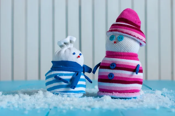 Couple of Hand Made Snowman with striped sweaters on wooden background — Stockfoto