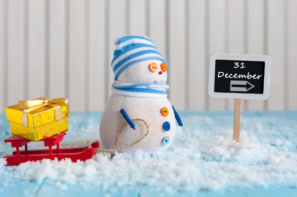 Word December 31 written on direction sign and Snowman with gift, red sled. Christmas, New year decorations. — Stockfoto