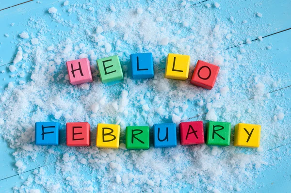 Hello February. Cube calendar for february on wooden surface with snow — Φωτογραφία Αρχείου