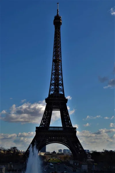 City sign of the Paris, France: Eiffel. Statue of Eiffel made of full metal and steel, Paris ,France during light cloudy day and blue sky.