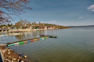Golyazi (Apolyont), uluabat Gölü, Bursa Türkiye. 22.01.2021. Uluabat Gölü 'nün panoramik manzarası ve renkli küçük liman ve büyük dağ sırtlı kasaba manzarası..