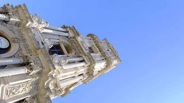 Old and ancient ottoman architecture and style clock tower in front of dolmabahce palace in stanbul near bosphorus sea during sunny day. 03.03.2021. stanbul Turkey.