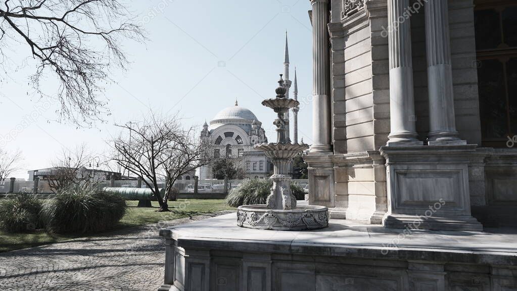 Dolmabahce mosque from dolmabahce palace and clock tower. Baroque and old ancient ottoman architectural mosque of dolmabahce near istanbul bosphorus.sunshine and sunny day. 04.03.2021. stanbul Turkey