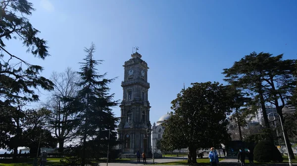 Old and ancient ottoman architecture and style clock tower in front of dolmabahce palace in stanbul near bosphorus sea during sunny day. 03.03.2021. stanbul Turkey.