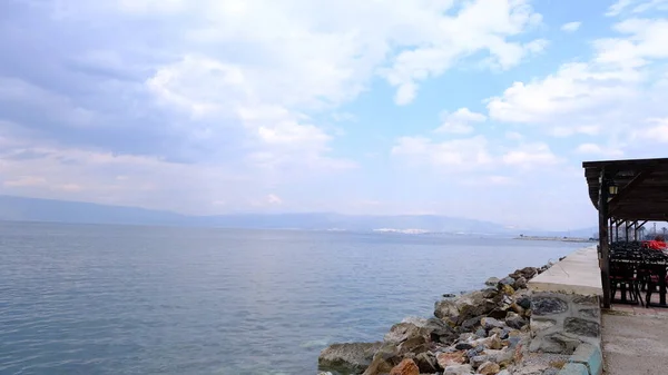 Bursa Turkey 15.03.2021. Seaside and shore of marmara sea Kursunlu side during overcast weather and small cafe chairs and tables. it is closed due to the pandemic lockdown.