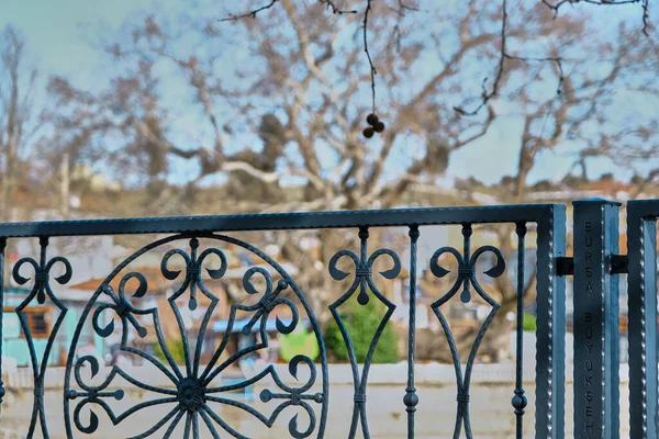 Metal frame and railing in Golyazi, turkey with old town blurred background. Black frame and wooden table.