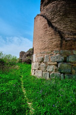 İznik şehir duvarının (nicaea) köşesi Bursa. Kırmızı tuğlaların arkasında şehir duvarı ve küçük yürüyüş yolu ve yeşil çimlerin etrafındaki patika.