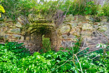Nicaea 'daki eski ve antik şehir duvarı (iznik Bursa) Bizans tarafından yıkıntı ve taş mezarlarla kurulmuş, güneşli bir günde yeşil çimenler ve sarı çiçekler ve büyük çimenler boyunca uzanan küçük patika..
