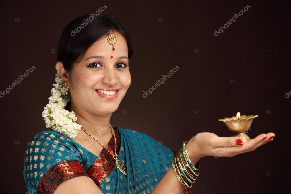 Beautiful traditional woman holding oil lamp light — Stock Photo