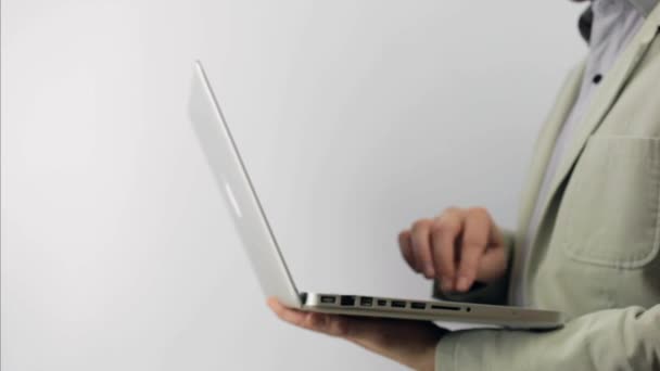 Hombre de negocios usando su cuaderno en traje blanco — Vídeos de Stock