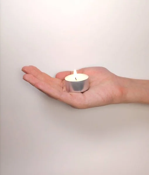 Burning Candle Lies Hand White Background — Stock Photo, Image