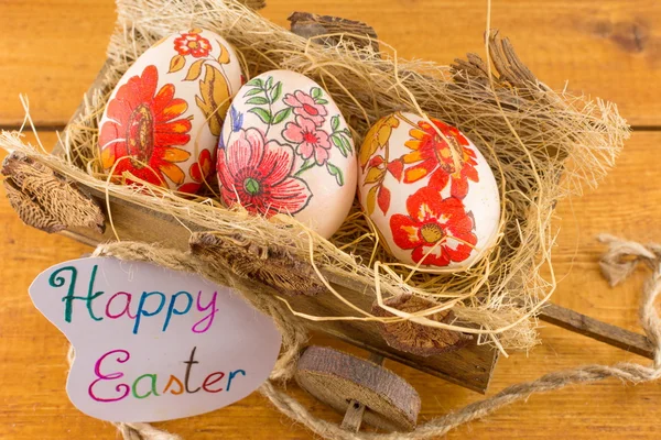 Decoupage decorated Easter eggs in old wagon — Stock Photo, Image